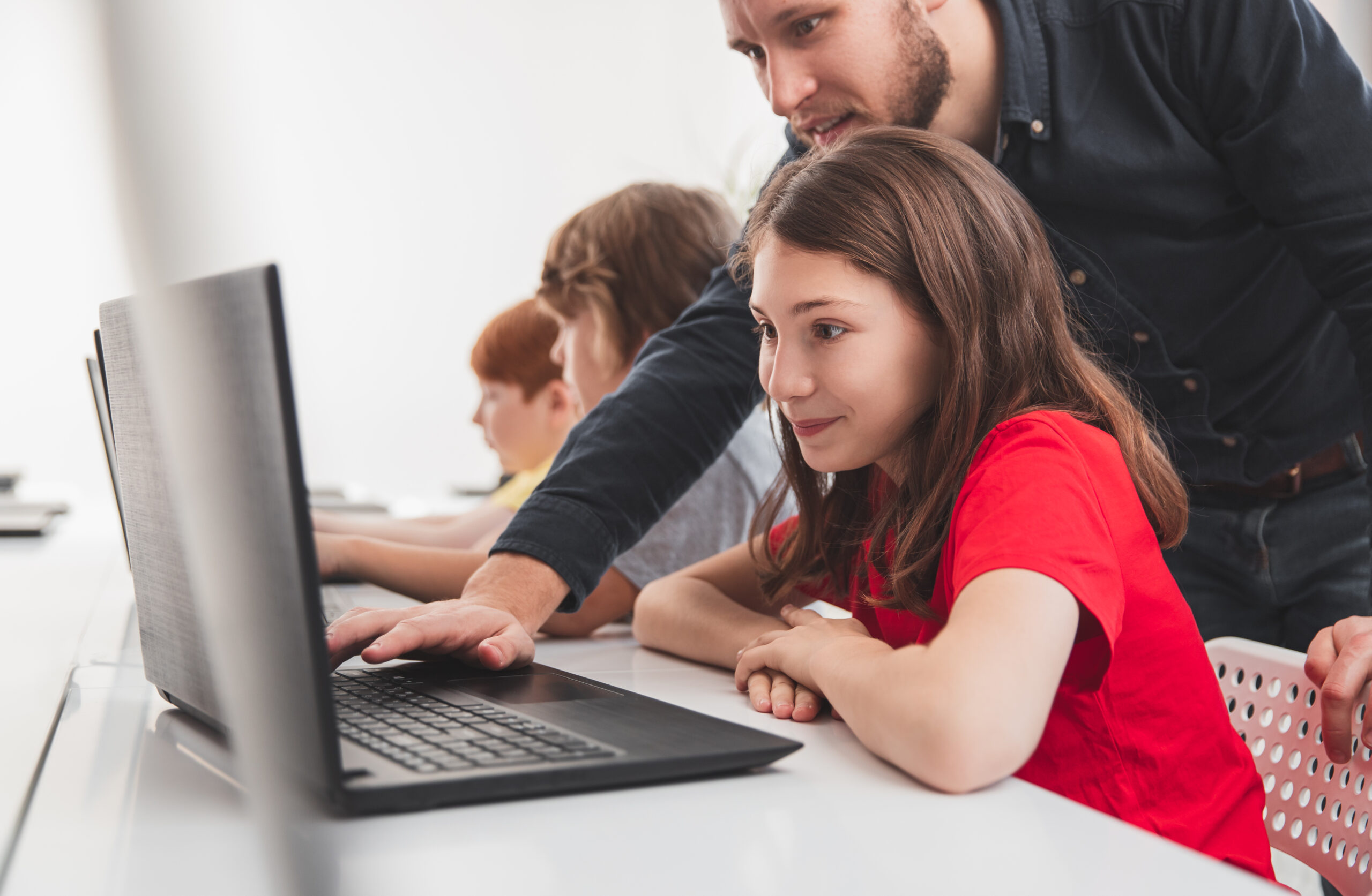 schoolgirl-teacher-during-computer-class-scaled.jpg