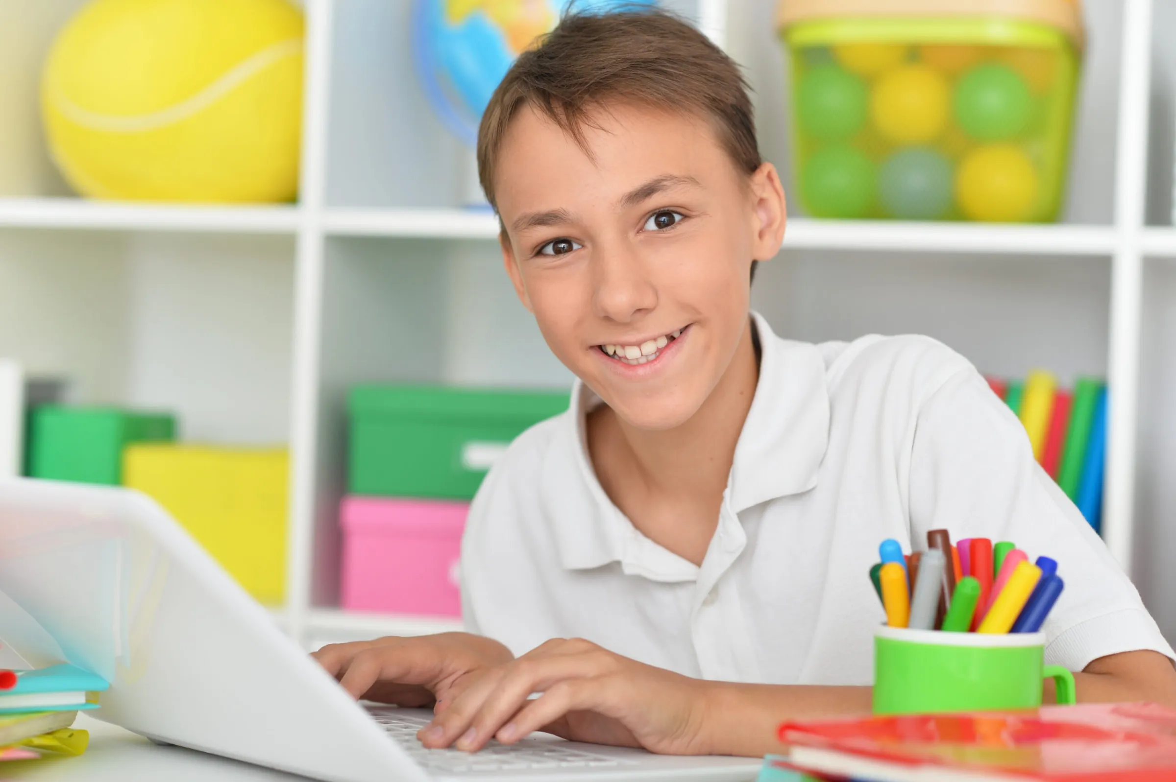 close-up-porait-cute-boy-using-laptop-home-scaled